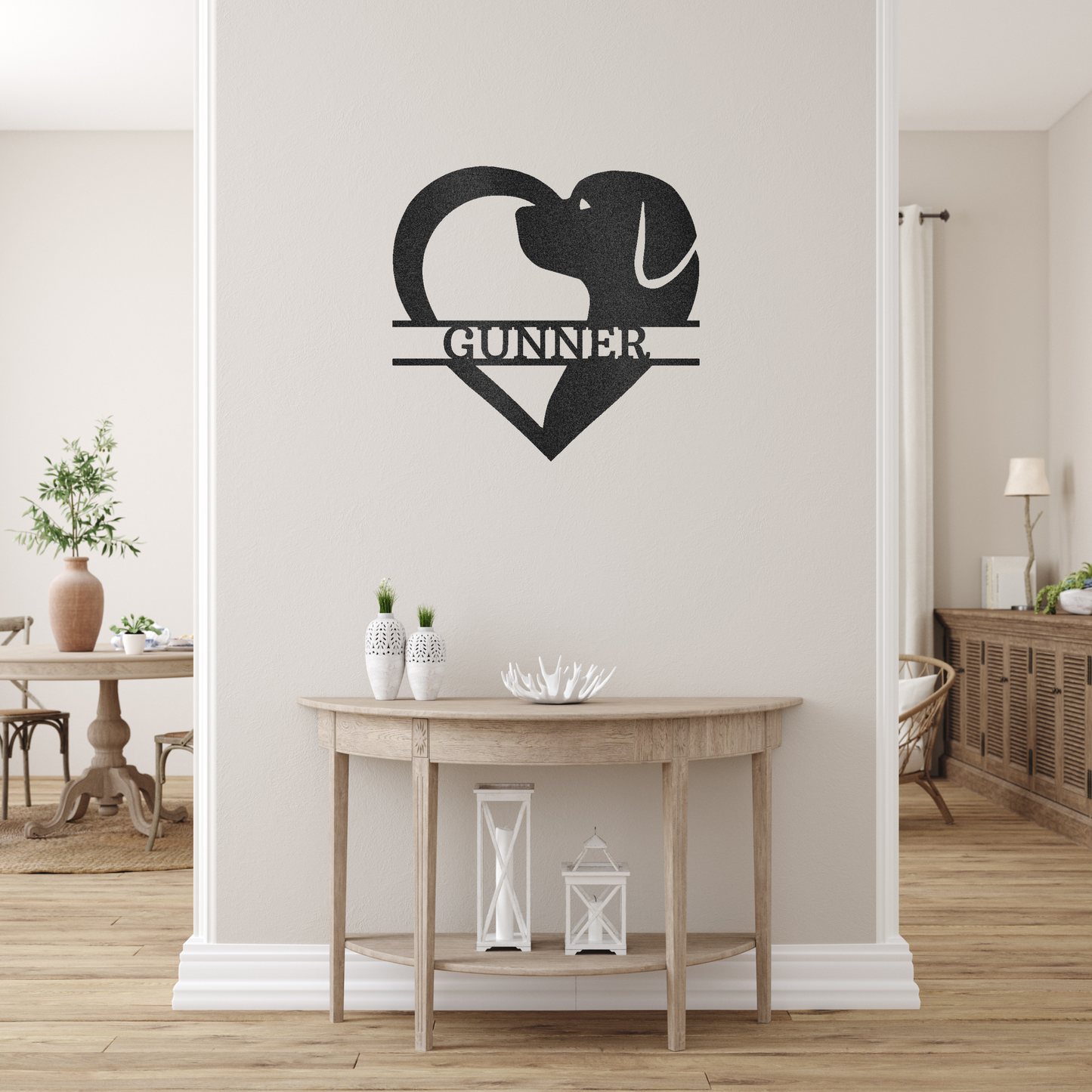 dog silhouette heart with personalized name metal wall decor with black powder coat finish hanging on an  off-white cream accent wall above a table