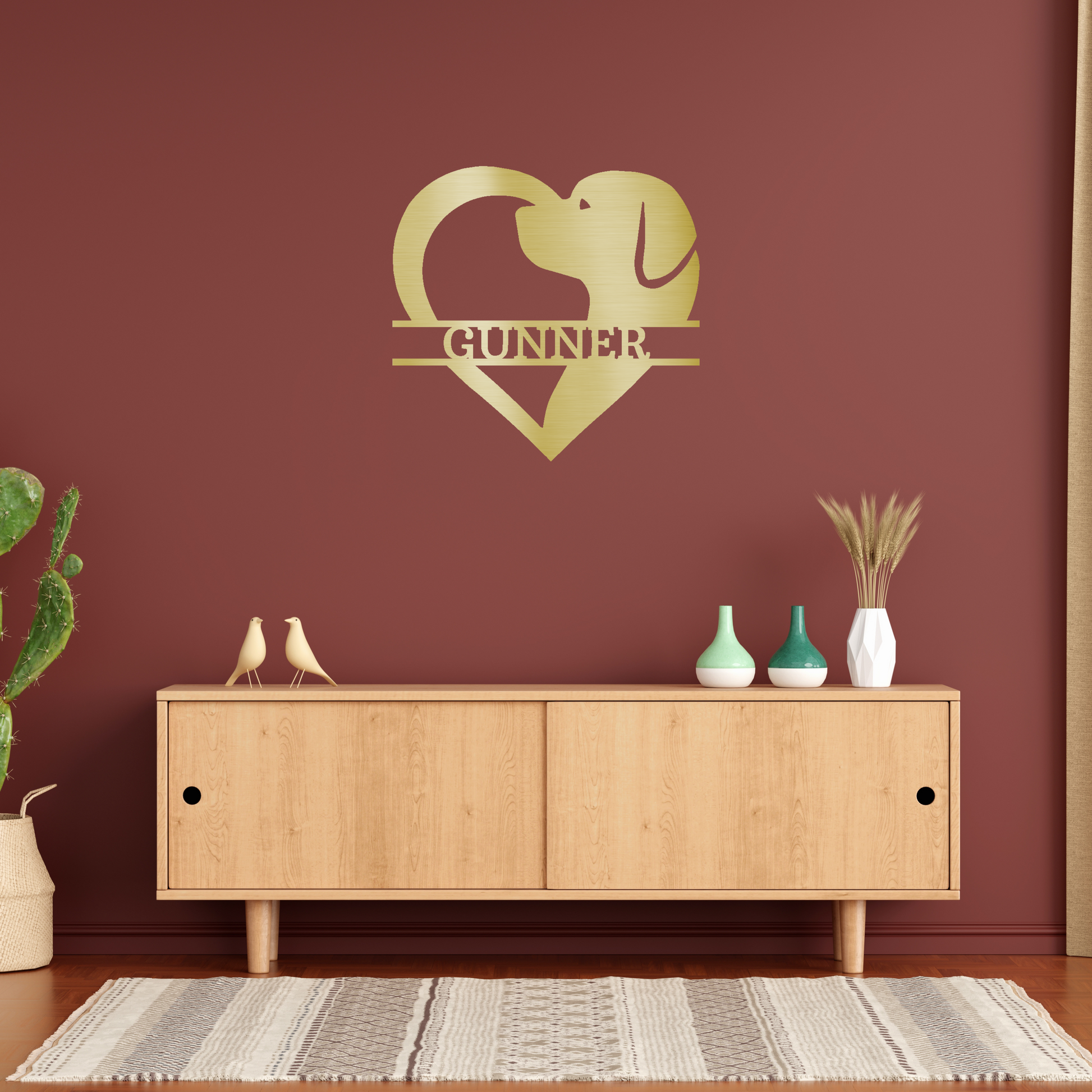 dog silhouette heart with personalized name metal wall decor with gold powder coat finish hanging on a rusty red accent wall above a table