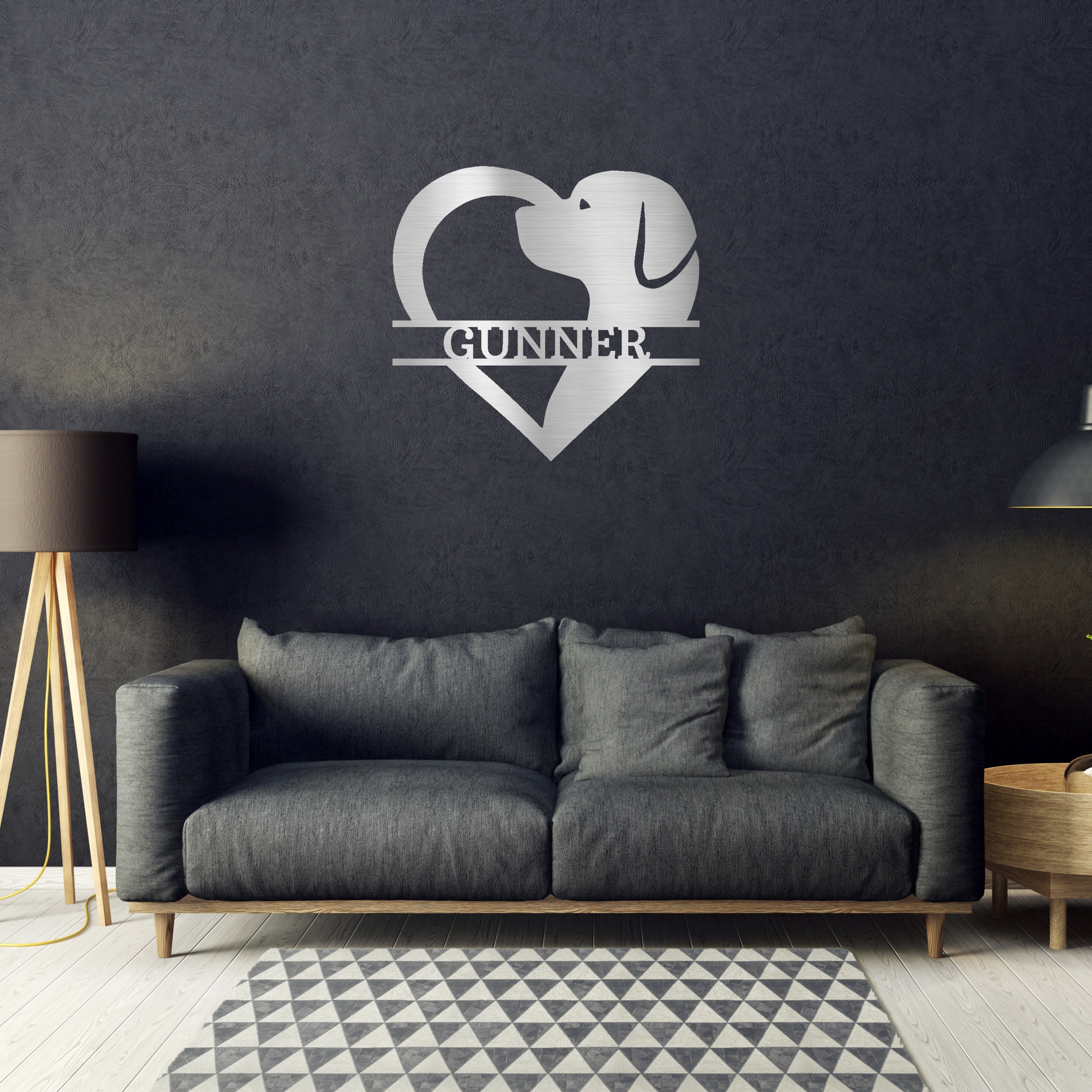 dog silhouette heart with personalized name metal wall decor with silver powder coat finish hanging on a black accent wall above a sofa