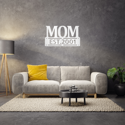 scripted MOM plaque with personalized  date of motherhood, powder coated white finish metal wall decor, hanging on a charcoal grey accent wall over a grey sofa | Home Accent Studio