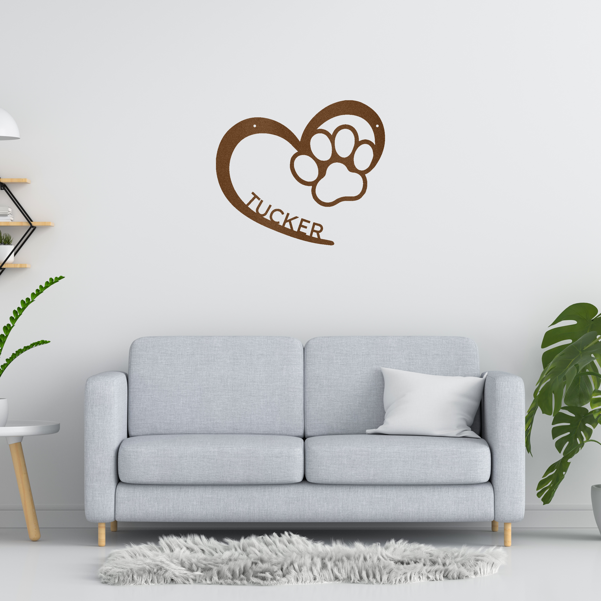 an open heart with a paw print in it, and personalized with a name, powder coat copper finish metal wall decor, hanging over a grey sofa on a white wall | Home Accent Studio